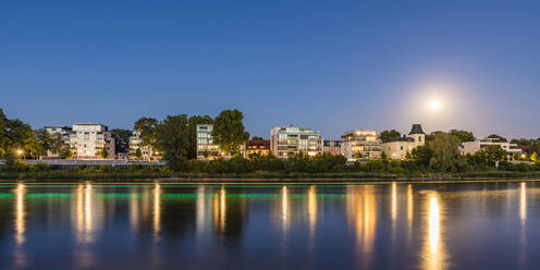 Germany, Saxony-Anhalt, Magdeburg, Panorama of riverside apartments of Werder district at dusk - WDF07171