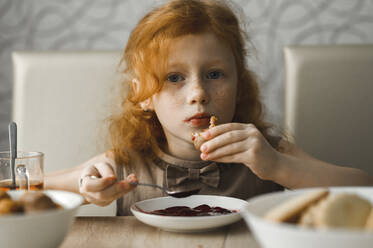 Redhead girl having breakfast at home - ANAF00604