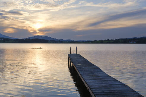 Germany, Bavaria, Jetty on shore of Lake Hopfen at sunset - WIF04648