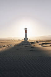 Shadow of lighthouse on sand at beach - MMPF00540