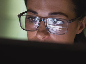 Computer programmer wearing eyeglasses looking at codes - ABRF01032