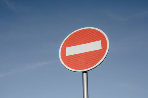 No entry sign board pole under blue sky - OSF01183