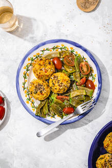 Plate of rice muffins with cherry tomato and green bean salad - FLMF00877
