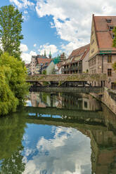 Germany, Bavaria, Nuremberg, Henkersteg bridge stretching across Pegnitz river - TAMF03680