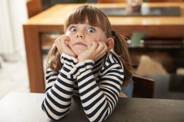 Girl with bangs leaning on table at home - PMF02432