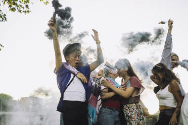 Happy friends enjoying while dancing together during LGBTQIA rights parade - MASF33585