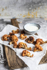 Barbecue cauliflower wings with sauce kept on table - SBDF04572