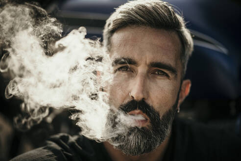 Mature man with beard smoking cigarette - MJRF00797