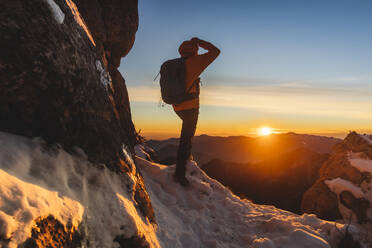 Hiker enjoying sunset standing on mountain - MCVF01035