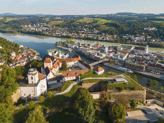 Germany, Bavaria, Passau, Aerial view of Veste Oberhaus fort with confluence of Danube and Ilz rivers in background - TAMF03782