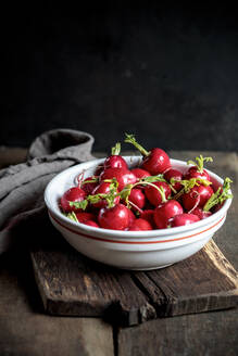 Fresh radishes in bowl at table - SBDF04590