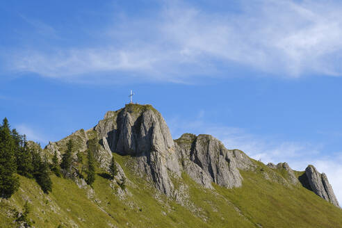 Summit cross on top of Tegelberg mountain under blue sky - WIF04657