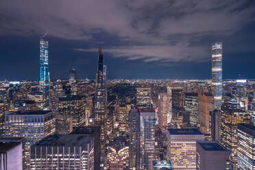 Aerial view of high rise buildings located on street of Manhattan against cloudy night sky in New York, USA - ADSF42079