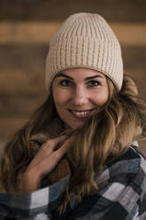 Smiling beautiful blond woman wearing knit hat - JOSEF15534