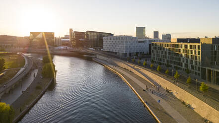 Germany, Berlin, Elevated view of Spree river flowing through city at sunset - TAMF03804