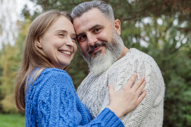 Happy couple wearing sweaters embracing each other - OSF01223