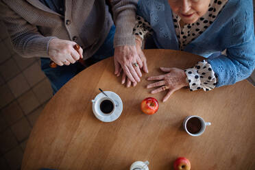 A top view of elderly couple enjoying breakfast in nursing home care center. - HPIF03635