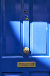 Sunlight on blue wooden house door - VEGF06107