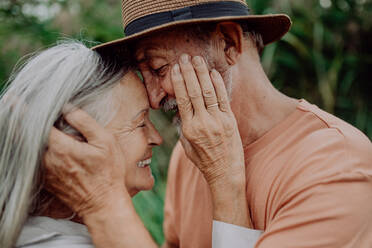 Portrait of senior couple in love, standing outdoor in the nature. - HPIF03739