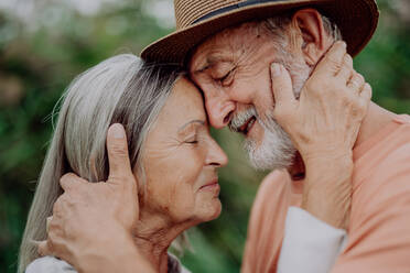 Portrait of senior couple in love, standing outdoor in the nature. - HPIF03740