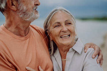 Senior couple relaxing and having romantic moment at the autumn sea. - HPIF03746