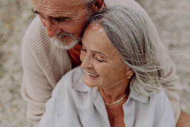 Senior couple relaxing and having romantic moment at the autumn sea. - HPIF03760