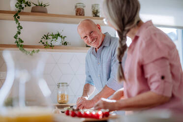 A senior couple cooking together at home. - HPIF03864