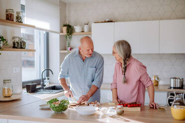 A senior couple cooking together at home. - HPIF03866