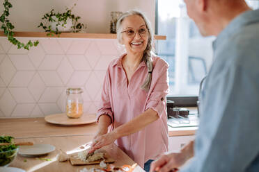 A senior couple cooking together at home. - HPIF03867