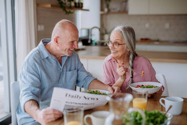 Ein glückliches Seniorenpaar beim gemeinsamen Abendessen zu Hause. - HPIF03876