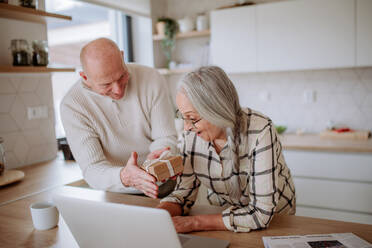 A happy senior woman getting present from her husband. - HPIF03902