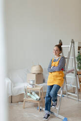 Happy young woman having break during renovation her house. - HPIF04282