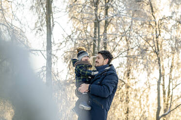 Happy father carrying son in park - ANAF00676