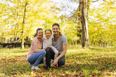 Happy parents with daughter in park - DIGF19678