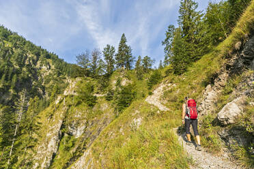 Germany, Bavaria, Female hiker walking through Rappinschlucht to Rabenkopf - FOF13237