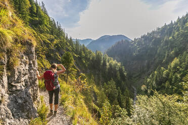 Germany, Bavaria, Female hiker walking through Rappinschlucht to Rabenkopf - FOF13238