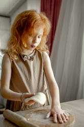 Girl with dough preparing cheesecake at home - ANAF00715