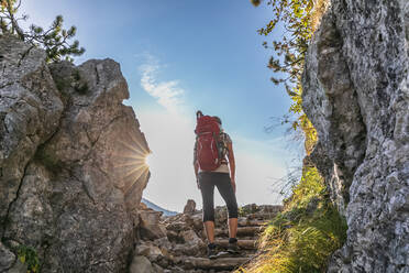 Germany, Bavaria, Female hiker standing on stone steps leading to summit of Rotwand mountain - FOF13256