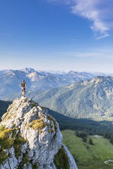 Germany, Bavaria, Male hiker standing on summit of Taubenstein mountain - FOF13259