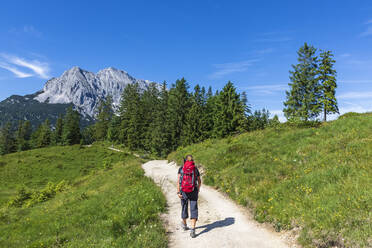 Germany, Bavaria, Female hiker following trail in Wetterstein mountains - FOF13288