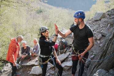 Man & woman sort rock climbing gear during early morning in mountains stock  photo