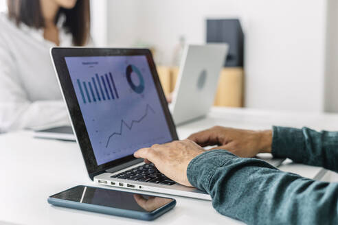 Hands of businessman using laptop at desk - XLGF03185