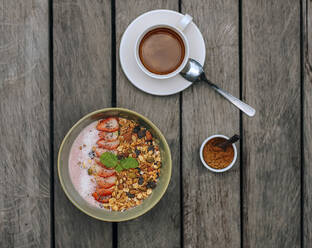 Cup of coffee and bowl of strawberry muesli - KNTF06871