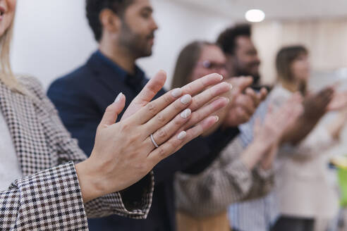 Business people clapping hands after a presentation in office - PNAF04714