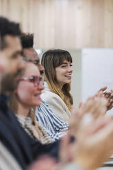 Business people clapping hands after a presentation in office - PNAF04792