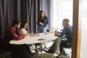 Coworkers talking in office conference room - FOLF12058