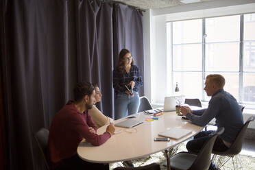 Coworkers talking in office conference room - FOLF12062