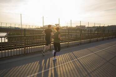 Couple jogging together on bridge - FOLF12111