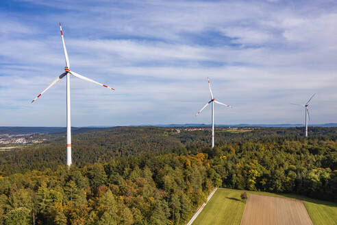 Germany, Baden-Wurttemberg, Aerial view of wind farm surrounded by autumn forest - WDF07212