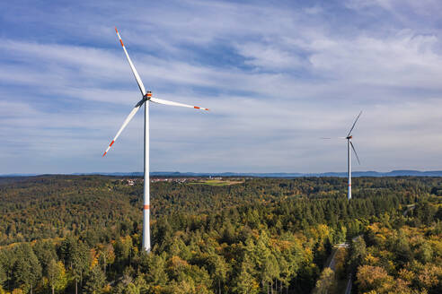 Germany, Baden-Wurttemberg, Aerial view of wind farm surrounded by autumn forest - WDF07213